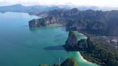 Turkuaz suların dramatik kireçtaşı kayalıklarıyla buluştuğu Railay Sahili Krabi Tayland 'ın muhteşem güzelliğini yaşayın. Bu tropik cennetin dingin plajlarını ve yemyeşil sularını keşfedin..