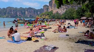 Tatilcilerin güneşlendiği Krabi Tayland 2 Şubat 2025 sıcak suların tadını çıkardığı ve nefes kesen kireçtaşı kayalıklarının yakınındaki çeşitli aktivitelere katıldığı yer. Kalabalık plaj mevsiminde