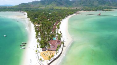 Koh Mook Adası 'nın nefes kesici manzarasını keşfedin. Turkuaz sular, palmiye ağaçlarıyla kaplı el değmemiş plajları kucaklıyor. Bu tropikal kaçışı bekleyen sakin atmosferi ve nefes kesici manzarayı keşfedin..