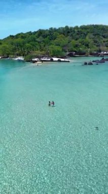 İki maceracı, yemyeşil ve kayalık kıyılarla çevrili Koh Kham Adası 'nın kristal berrak turkuaz sularında yürüyor. Tayland 'da mükemmel bir tropikal cennet bekliyor.