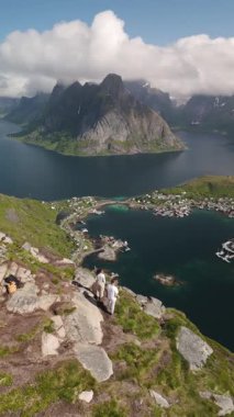 Lofoten Norveç 'in nefes kesici manzarası engebeli dağlar ve sakin sular maceracılar için mükemmel bir zemin oluşturur. Yürüyüşçüler çarpıcı manzaranın tadını çıkarırken kayalık patikaları aşıyorlar..