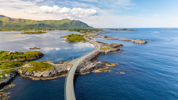Explore the captivating coastal road winding through serene waters and lush hills in Atlantic Ocean Road, Norway