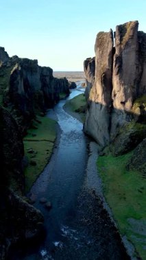 Görkemli kayalıklar Fjadrargljufur Kanyonu 'ndaki dolambaçlı bir nehri kucaklayarak İzlanda' nın engebeli arazisinin doğal güzelliğini gözler önüne seriyor. Macera arayanlar ve doğa severler için mükemmel bir yer..