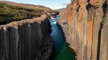 Studlagil Kanyonu 'nun çarpıcı jeolojik oluşumlarına tanık olun. Zümrüt nehir bazalt sütunlar arasında akıyor. Bu doğa harikası İzlanda manzaralarında görülmesi gereken bir şey..