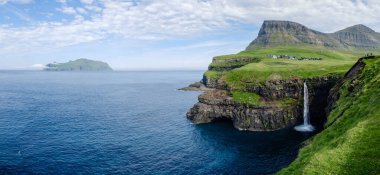 Nefes kesici Mulafossur şelalesi, Gasadalurs tarafından çerçevelenmiş, büyüleyici güzellikteki Faroe Adaları 'nı gözler önüne seren Atlantik' e daldı..