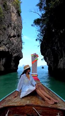 A serene day in Krabi, Thailand, as a woman relaxes on a traditional longtail boat, surrounded by the stunning limestone cliffs and the clear turquoise waters of Koh Hong