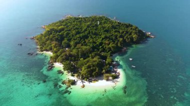 Explore Koh Munork tropical island in Thailand featuring lush greenery, white sandy beaches, and crystal-clear waters. Enjoy serene surroundings and vibrant marine life, perfect for relaxation.