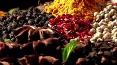 Canlı Spice Mix. Doğal baharatların detaylı görüntüsü: sarı zerdeçal tozu, kimyon tohumu, karabiber, yeşil kakule podları.