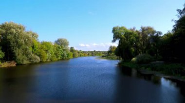 Ukrayna 'nın Zhytomyr bölgesinde yeşil ağaçlar arasında sakin nehir Teteriv. 