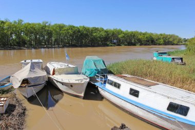 The boats standing at the shore of Parana river in San Nicolas Argentina clipart