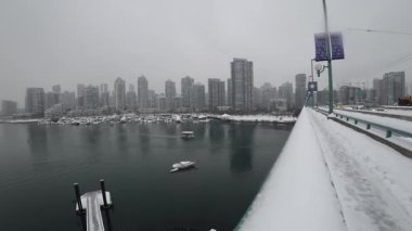 Timelapse of boats under bridge and cars passing by on a winter day in Vancouver