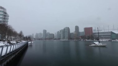 4K timelapse of Vancouver downtown duting a winter snowy day with moored yacht