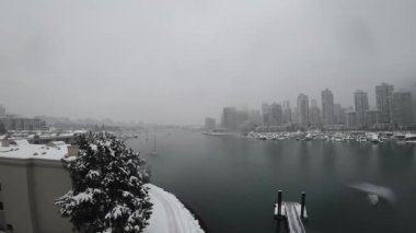 Boats timelapse during snowy winter day in Vancouver, Canada near downtown