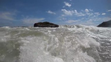Slo-mo footage captures the dance of underwater life and waves crashing beach
