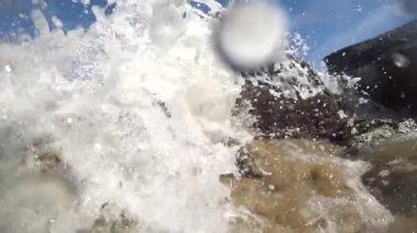 Raw power of slow-motion waves crashing against rocks in the ocean