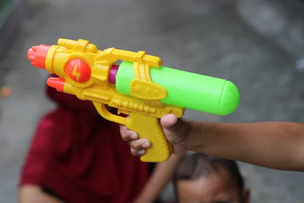 photo of toy gun being carried