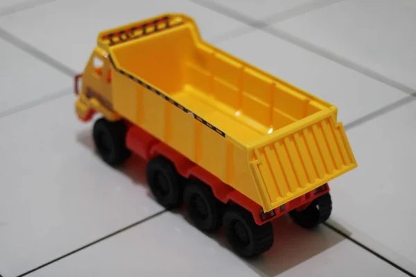Photo of a yellow children\'s toy truck