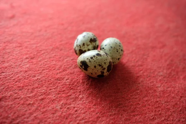 赤を背景にしたウズラの卵の写真 — ストック写真
