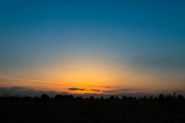 The predawn sky above the horizon on an early summer morning. 