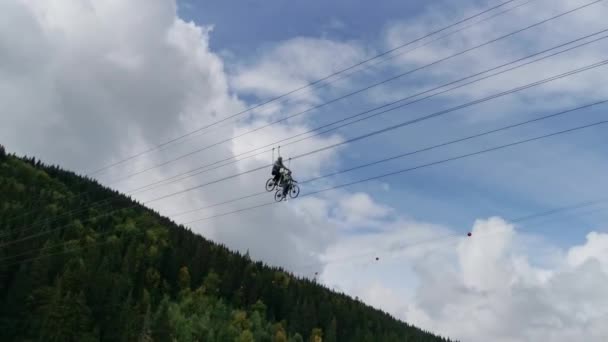 People Ride Bicycles Wires Lake Type Zipline Attraction — Stock Video