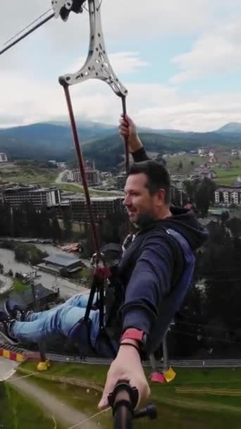 Man Takes Selfie Video Using Selfie Stick Riding Zip Line — Stock Video