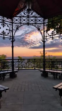 Picturesque pavilion with viewing platform in the park on St. Volodymyr's Hill in Kyiv in the early morning hours. Vertical video