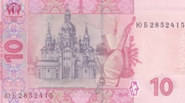 Ukrayna 10 Hryvnia 'nın ters tarafına dinamik zoom görüntüsü, bandura, kitaplar, mürekkep hokkası ve mum ile geleneksel kompozisyona odaklanarak Mazepa döneminin kültürel mirasını temsil ediyor.
