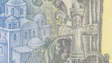 Ukrayna 'ya ait ayrıntılı bir bakış açısı. Bir Hryvnia banknotunun ters tarafında geleneksel güç sembolleri var. Şahin, kılıç, gürz ve haç gibi.