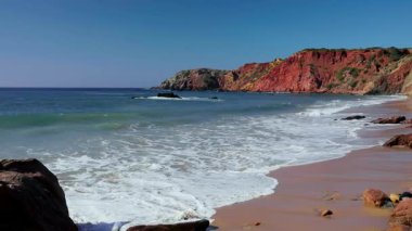 Kristal mavisi Atlantik Okyanusu 'na karşı dramatik kızıl uçurumlarla büyüleyici batı Portekiz kıyıları. Güçlü dalgalar altın kumlu plajlara vuruyor. Fotoğrafçılar için mükemmel.