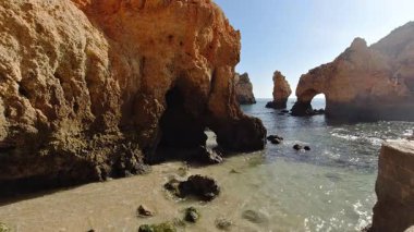 Portekiz, Lagos yakınlarındaki Ponta da Piedade 'deki altın kireçtaşı kemerlerinin ve kaya oluşumlarının nefes kesici manzarası, burada dramatik aşınmış uçurumlar kristal berraklığında turkuaz sularla buluşuyor ve Algarve' nin en muhteşem kıyı manzaralarından birini oluşturuyor.