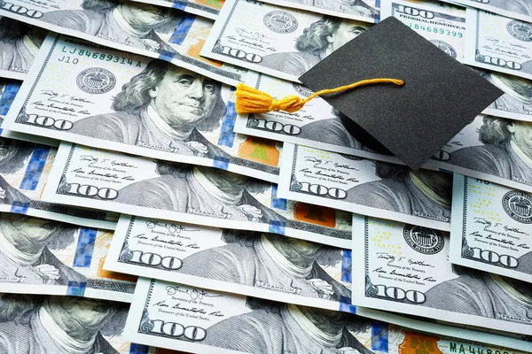 A Graduation cap on the stack of money. Student loan concept.