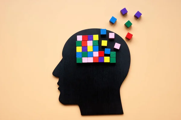 stock image Head with colored cubes, part of which is lost as a symbol of dementia.