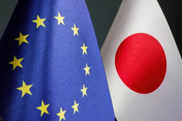 The flags of the EU and Japan are side by side as concept of trade relations.