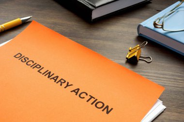 Disciplinary action documents for hr on desk.