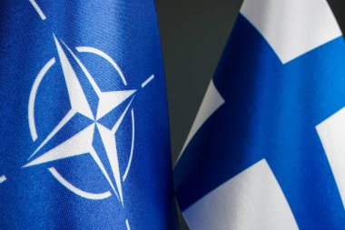 KYIV, UKRAINE - January 10, 2023. Flags of NATO and Finland as a symbol of membership. Editorial.