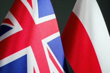 Nearby are the flags of Great Britain and Poland as symbol of cooperation.