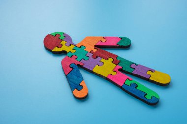 Figure of man made of multi-colored puzzle pieces. Autism or neurodiversity concept. clipart
