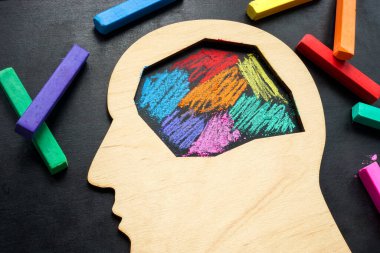 Head is painted with colored crayons. Neurodiversity or autism concept.