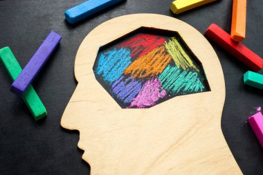 Head is painted with colored crayons. Neurodiversity or autism concept. clipart