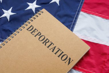 US flag and deportation law book on it. clipart