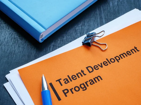 Talent development program, a notepad and pen on the desk.