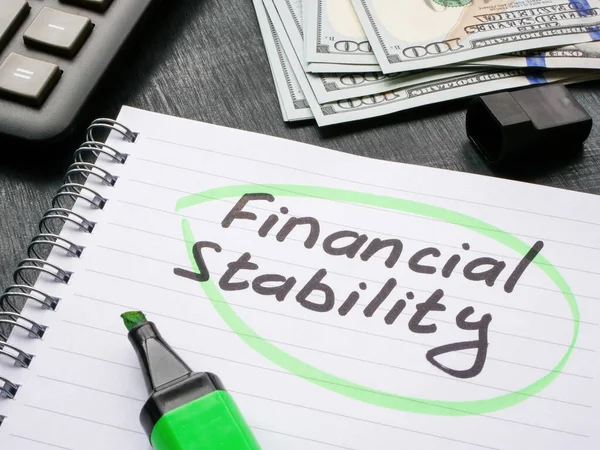 The inscription financial stability is circled in notebook.