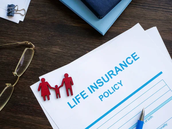 Life insurance policy and figurines of a family.