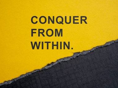 A torn piece of paper and motivation phrase conquer from within. clipart