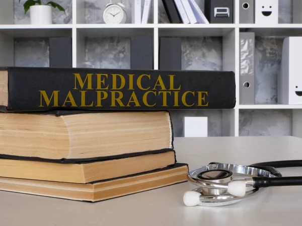 Medical malpractice law book and stethoscope.