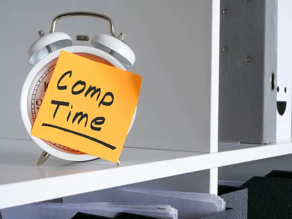 White Alarm Clock Office Shelf Compensation Comp Time Inscription Stock Image