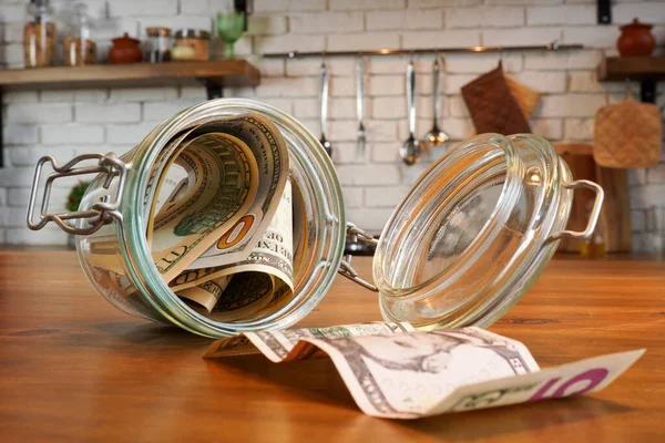 Glass jar with money at a home as personal finance and savings.