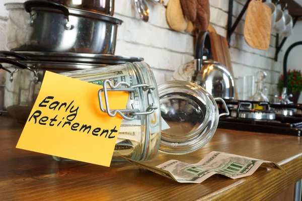 Early retirement concept. Glass jar with cash on the home table.