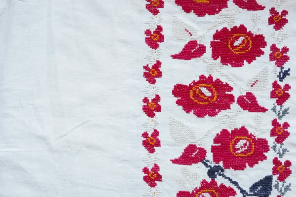 Fabric background with embroidered national ethnic ornament. Ukrainian culture concept.