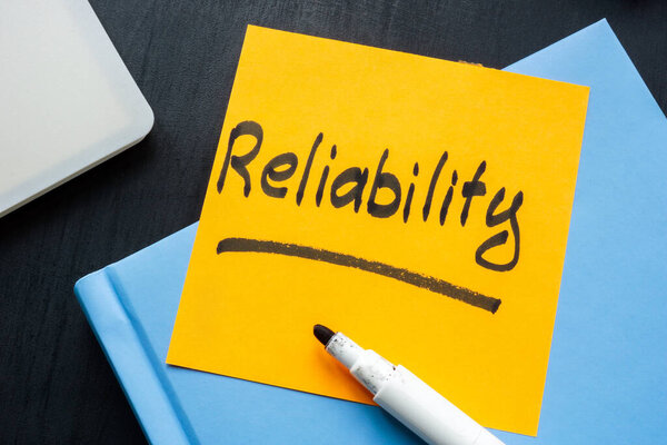 Reliability concept. Handwritten note on yellow sticky note.